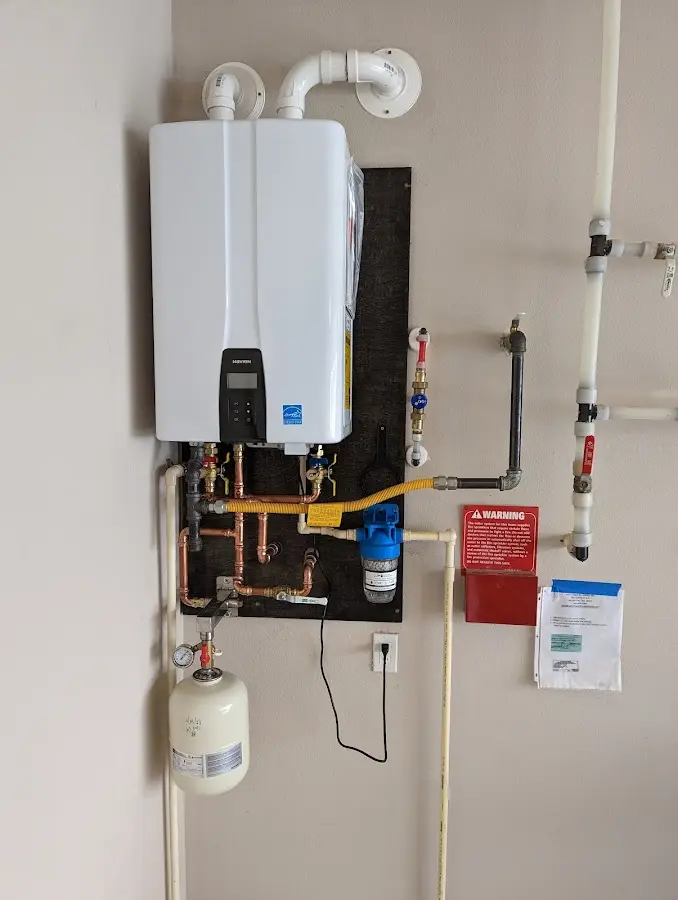 Professional plumber installing copper piping in a Ainaloa home